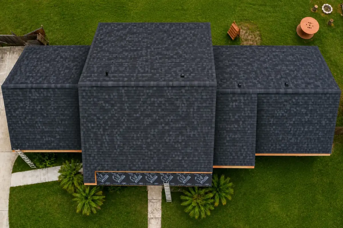 Drone view of a newly installed charcoal architectural shingle roof on a Rio Grande Valley home