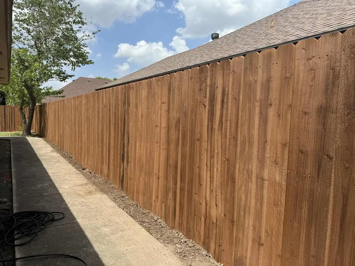 New cedar privacy fence with vertical dog-ear pickets along a Rio Grande Valley home