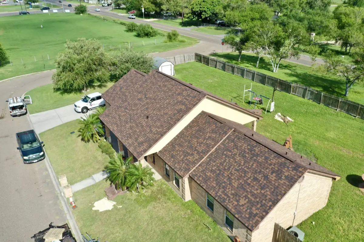 Drone view of a completed brown architectural shingle roof on a Rio Grande Valley brick home