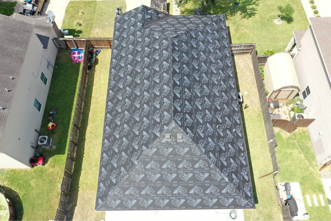 Roof covered with new underlayment during a hail claim replacement in Mission