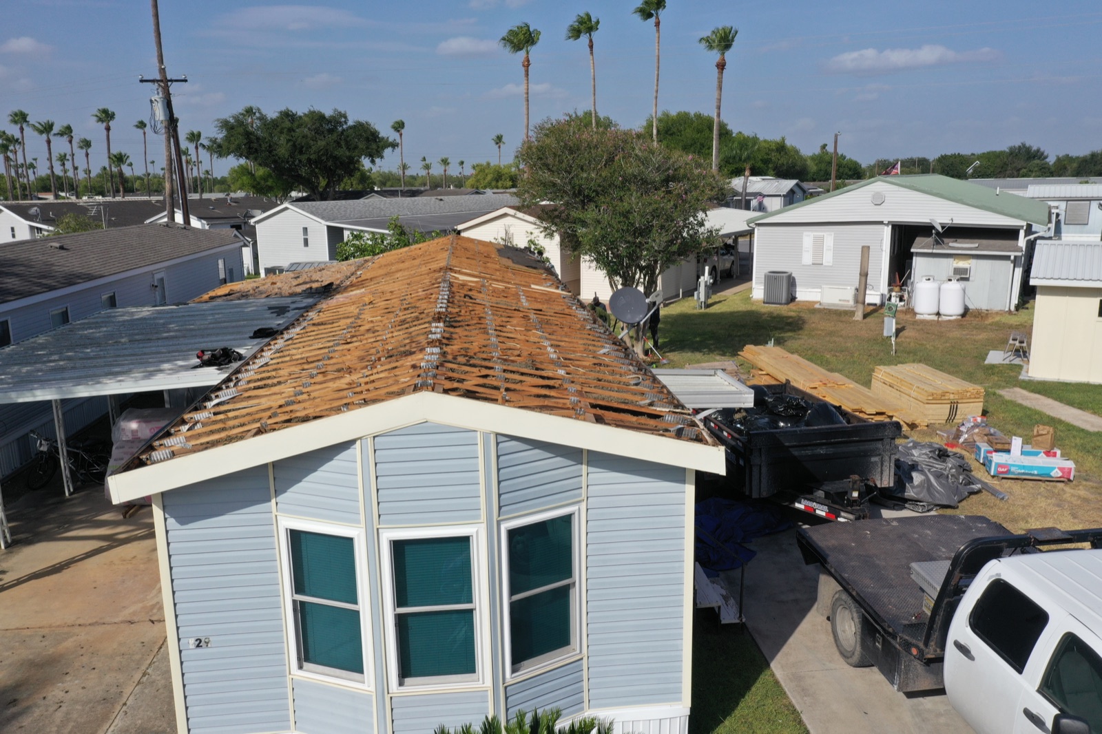 Texas Contractors crew tearing off an old roof to the deck